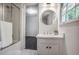 Bathroom featuring updated vanity, modern lighting, bathtub and shower combination, and glass door at 2820 Georgian Ter, Marietta, GA 30068