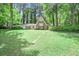 Charming single-Gathering home boasts a stone front facade, lush greenery, and a well-manicured front yard at 2820 Georgian Ter, Marietta, GA 30068