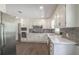 Well-lit kitchen featuring white cabinets, modern appliances, gray subway tile backsplash, and hardwood floors at 2820 Georgian Ter, Marietta, GA 30068