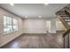 Spacious living room showcasing wood-look flooring, natural light and a staircase to the second level at 2820 Georgian Ter, Marietta, GA 30068