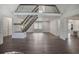 Airy living room with vaulted ceilings, modern flooring, and a staircase leading to a mezzanine at 2820 Georgian Ter, Marietta, GA 30068