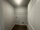 Convenient laundry room with vinyl floors and shelving at 35 Yellow Brick Way, Covington, GA 30014