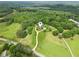 High aerial view of the property showcasing its lush surroundings and long driveway at 5945 Bannister Rd, Cumming, GA 30028