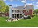 Backyard patio with outdoor seating area and fireplace, ideal for relaxing and enjoying the serene surroundings at 5945 Bannister Rd, Cumming, GA 30028
