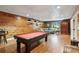 Finished basement with a pool table, wood paneling, and bar at 5945 Bannister Rd, Cumming, GA 30028