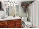This bathroom features a shower, toilet, vanity, framed mirror, towels, and light-green walls at 5945 Bannister Rd, Cumming, GA 30028