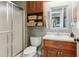 This bathroom features a shower, toilet, sink, cabinet and mirror at 5945 Bannister Rd, Cumming, GA 30028