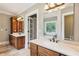 Bathroom with double vanity, quartz countertop, large mirror, and access to the main bedroom at 5945 Bannister Rd, Cumming, GA 30028