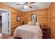Charming bedroom with wood paneled walls, ceiling fan, and cozy decor at 5945 Bannister Rd, Cumming, GA 30028