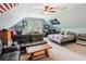 This carpeted bedroom features a ceiling fan, a leather couch, a bed and memorabilia at 5945 Bannister Rd, Cumming, GA 30028
