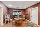This cozy dining room features hardwood floors, a round wood table, and a window at 5945 Bannister Rd, Cumming, GA 30028