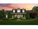 Charming home with a well-manicured lawn, beautiful landscaping, and a welcoming front entrance at 5945 Bannister Rd, Cumming, GA 30028