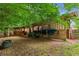 Outdoor horse shelter with ample space and protection from the elements, nestled in a wooded area at 5945 Bannister Rd, Cumming, GA 30028