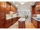 Large kitchen features custom cabinetry, stainless appliances, and an open design to the dining area at 5945 Bannister Rd, Cumming, GA 30028