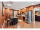 This kitchen features stainless steel appliances, wood cabinets, island with bar seating at 5945 Bannister Rd, Cumming, GA 30028