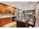 Spacious kitchen with wood cabinets, marble countertops, and an island with barstool seating at 5945 Bannister Rd, Cumming, GA 30028