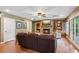 Cozy living room featuring fireplace, ceiling fan, recessed lights, and hardwood floors at 5945 Bannister Rd, Cumming, GA 30028