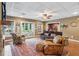 Open living room featuring a fireplace, large rug, hardwood floors, and doors to the backyard at 5945 Bannister Rd, Cumming, GA 30028
