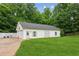 Detached outbuilding with multiple garage doors and ample storage space, set in a beautifully landscaped yard at 5945 Bannister Rd, Cumming, GA 30028