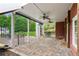 Open patio features brick pavers, multiple ceiling fans, white support beams, and outdoor seating at 5945 Bannister Rd, Cumming, GA 30028