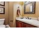 This powder room features a vanity, a mirror, neutral colored walls and an ornate framed mirror at 5945 Bannister Rd, Cumming, GA 30028