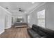 Bedroom featuring dark vinyl floors, a queen bed and leather sofa next to windows with blinds at 1560 Sarah M Harden Dr, Atlanta, GA 30311