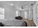Bedroom with gray walls, vinyl floors, bed, ceiling fan and black sofa, featuring great natural light at 1560 Sarah M Harden Dr, Atlanta, GA 30311