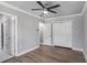 This bedroom features wood floors, light gray walls, and double-door closet at 1560 Sarah M Harden Dr, Atlanta, GA 30311