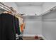 Organized walk-in closet with clothes hanging on racks and shoes on the floor at 1560 Sarah M Harden Dr, Atlanta, GA 30311