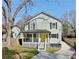 Charming two-story home with a welcoming front porch and a bright yellow door at 1560 Sarah M Harden Dr, Atlanta, GA 30311