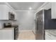Bright kitchen with granite countertops, tile floors, and stainless steel refrigerator and microwave at 1560 Sarah M Harden Dr, Atlanta, GA 30311