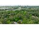 Aerial view of the neighborhood with mature trees near highway and city skyline in background at 2298 Pembrook Pl, Atlanta, GA 30324