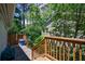 Backyard with a wooden stairway and lush greenery creating a private outdoor space at 2298 Pembrook Pl, Atlanta, GA 30324