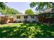 Wide backyard showcasing well-maintained lawn and mature trees, providing privacy and space at 2298 Pembrook Pl, Atlanta, GA 30324