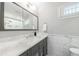 Bathroom with marble countertops, a large mirror, and a shower with a glass door, exuding elegance at 2298 Pembrook Pl, Atlanta, GA 30324