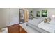 Bedroom features hardwood floors, an area rug, neutral tones, and is adjacent to the ensuite at 2298 Pembrook Pl, Atlanta, GA 30324