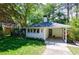 Charming home exterior featuring a carport, lush lawn and beautiful landscaping at 2298 Pembrook Pl, Atlanta, GA 30324