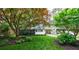 Beautifully landscaped front yard featuring mature trees and a cozy bungalow with a covered carport at 2298 Pembrook Pl, Atlanta, GA 30324