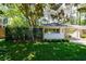 Home exterior with well-maintained lawn, privacy fence, carport and beautiful landscaping at 2298 Pembrook Pl, Atlanta, GA 30324