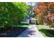 Quaint home surrounded by lush landscaping featuring a brick home with covered parking at 2298 Pembrook Pl, Atlanta, GA 30324