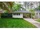 Lovely white brick home featuring a covered carport, tidy landscaping, and a privacy fence at 2298 Pembrook Pl, Atlanta, GA 30324