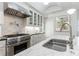 Kitchen boasts marble countertops, stainless steel appliances, and glass-front cabinets at 2298 Pembrook Pl, Atlanta, GA 30324