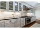 A well-lit kitchen features white cabinets, granite countertops, a stainless steel range, and subway tile backsplash at 2298 Pembrook Pl, Atlanta, GA 30324