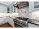 Gourmet kitchen featuring stainless steel appliances, a range hood, and white cabinetry at 2298 Pembrook Pl, Atlanta, GA 30324