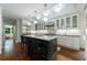 Stylish kitchen features white cabinets, stainless steel appliances, a marble island, and hardwood floors at 2298 Pembrook Pl, Atlanta, GA 30324