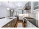 Gourmet kitchen with a stainless steel range, white cabinetry, and marble backsplash at 2298 Pembrook Pl, Atlanta, GA 30324