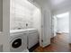 Laundry room features side-by-side washer and dryer, along with wire rack shelving for storage at 2298 Pembrook Pl, Atlanta, GA 30324