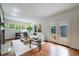 Inviting living room with a white sofa, hardwood floors, and double doors leading to an outdoor patio at 2298 Pembrook Pl, Atlanta, GA 30324