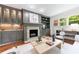 Bright living room featuring hardwood floors, a cozy fireplace, custom cabinetry and lots of natural light at 2298 Pembrook Pl, Atlanta, GA 30324
