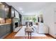 Cozy living room features a stone fireplace, custom built-ins, hardwood floors, and lots of natural light at 2298 Pembrook Pl, Atlanta, GA 30324